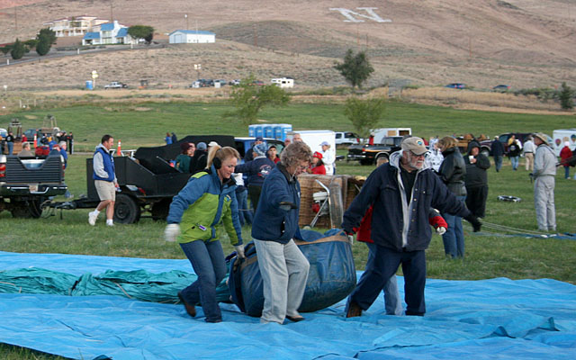 Some teams layout plastic sheeting to keep the balloon off the damp grass.