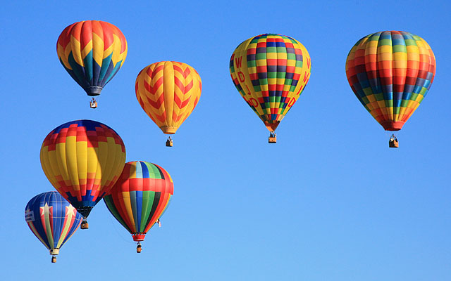 The lower left balloon is "Falling Star" piloted by Karen Brown of Reno. The balloon second from right is "WWJD"	piloted by Bill Woodhead of Grants Pass, Oregon and sponsored by St. Paul's Methodist Church.