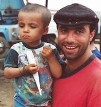 Little boy in dad's arms